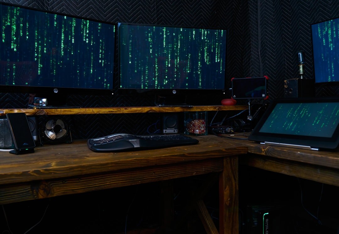 Broadcast engineer working at a signal processing workstation with multiple screens